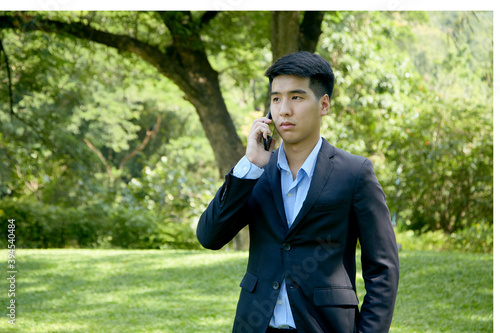 asian businessman working in park © 1981 Rustic Studio