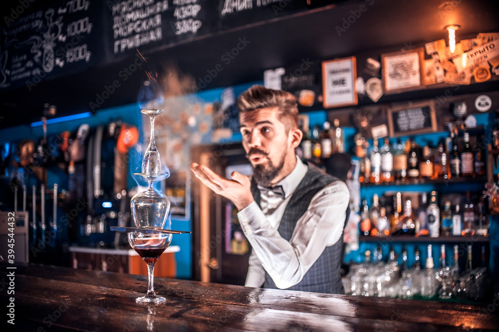 Barman makes a cocktail behind bar