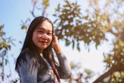 Asian women in Thailand smiling and with natural bokeh background