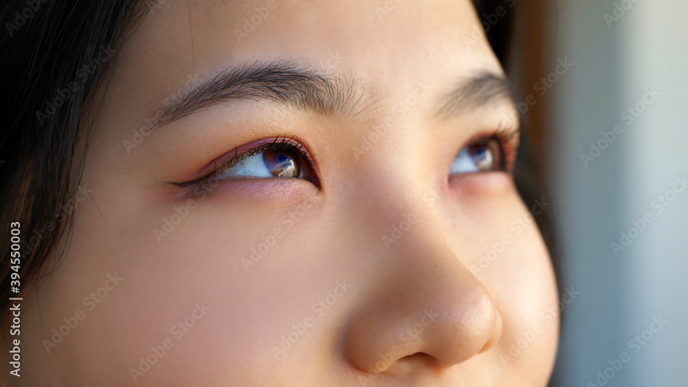 Close up, Eyes of happy young asian woman with pink eyeshadow looking through the window. High quality photo Close up, Eyes of happy young asian woman with pink eyeshadow looking through the window. High quality photo