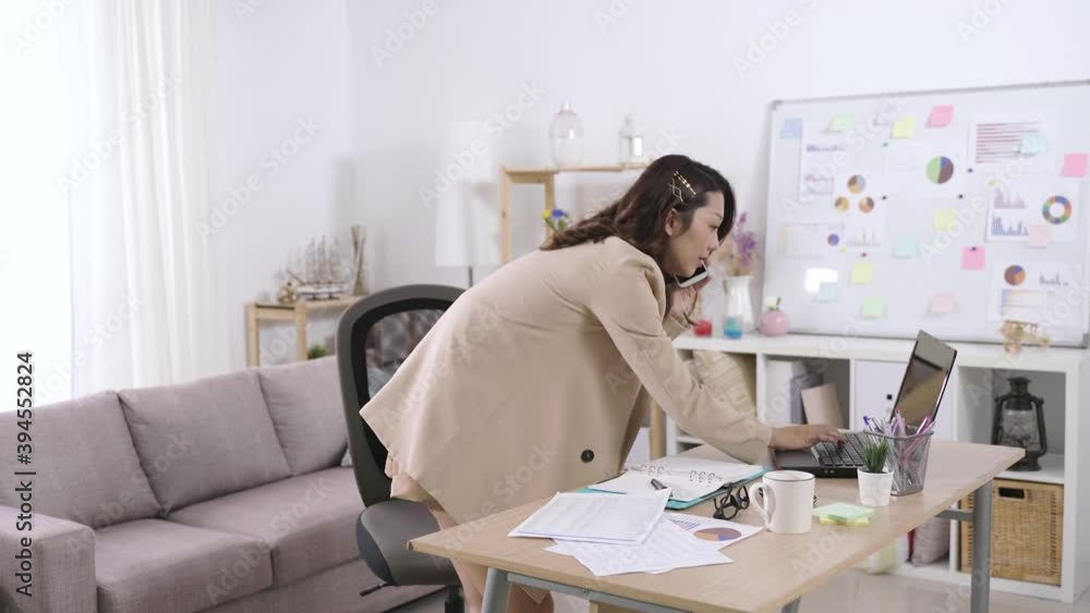contacting clients with smartphone. asian administrative assistant ...