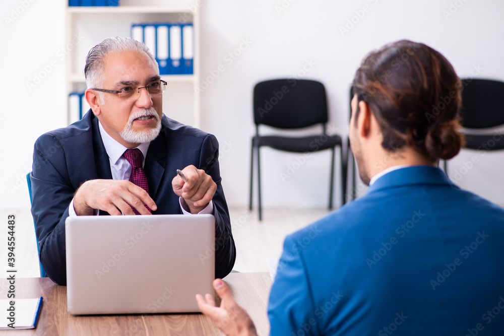 Young male candidate employee meeting with old recruiter Young male candidate employee meeting with old recruiter