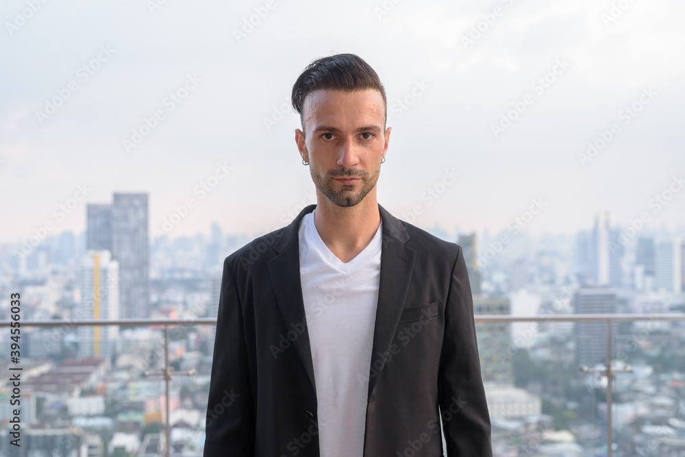 Portrait of businessman standing on the rooftop of a skyscraper Portrait of businessman standing on the rooftop of a skyscraper
