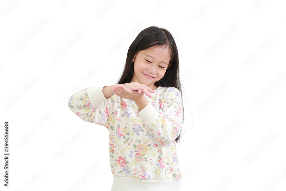 Little asian girl applying lotion in hands over white background Little asian girl applying lotion in hands over white background