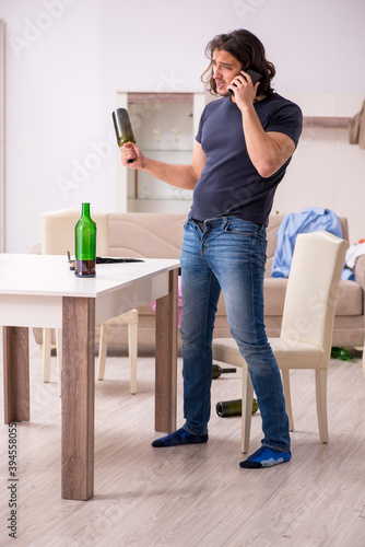 Young unemployed man drinking alcohol at home © Elnur