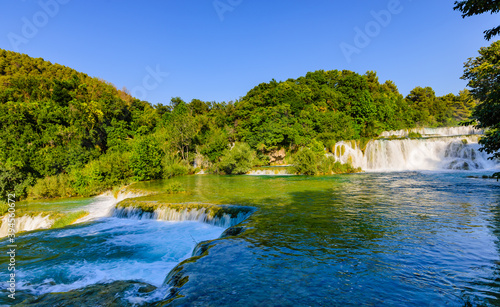 Beautiful cascade of waterfalls on the KRKA river during sunset. © a_mikhail