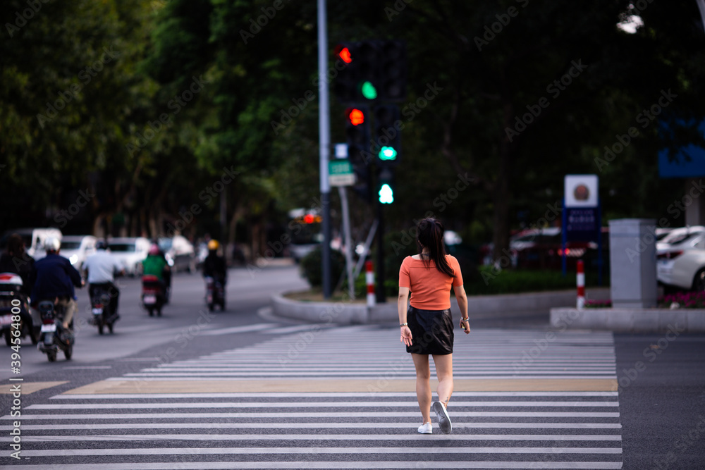 Portrait of happy asian girl enjoys traveling in the city in summer shot from behind. Woman walking during coronavirus covid-19 pandemic
