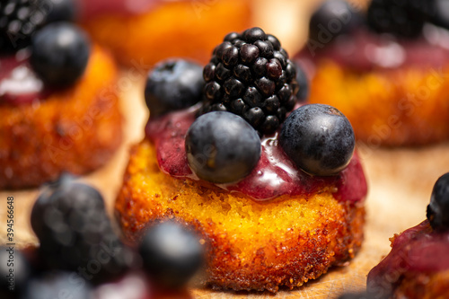 Obraz na plátně Upside-down berry cupcakes, food background.