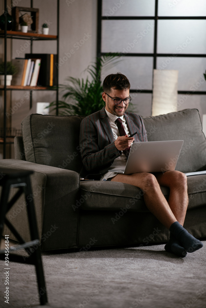 Businessman with no pants working at home. Young man using the laptop having video call. Businessman with no pants working at home. Young man using the laptop having video call.