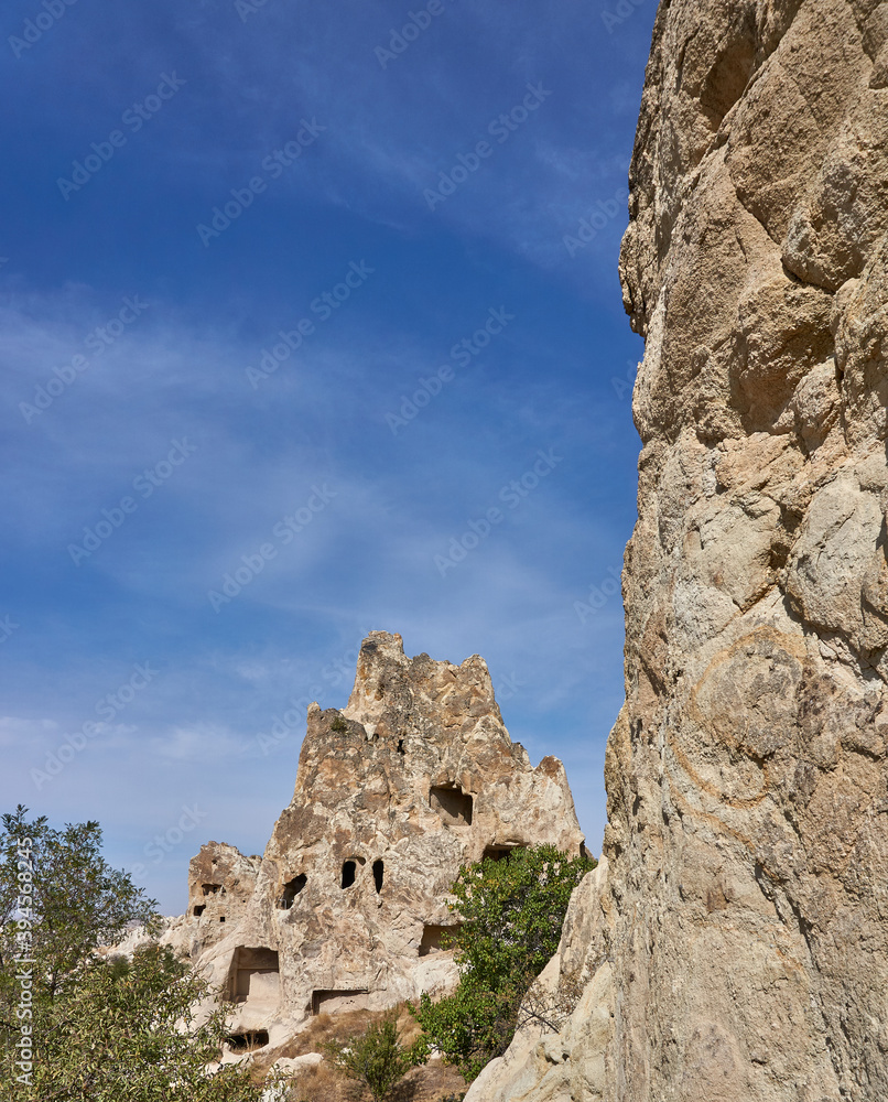 Ancient cave houses  and rock formations near Goreme, Cappadocia, Turkey