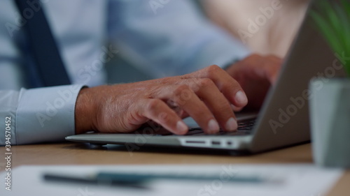 Businessman hands typing on laptop computer. Professional using modern computer