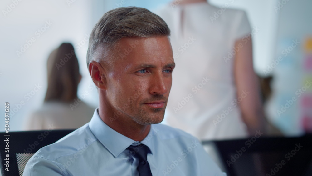 Fototapeta premium Thoughtful businessman working in office. Tired male executive breathing deeply