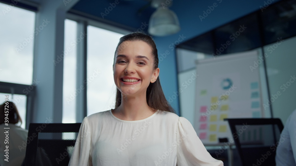 Cheerful businesswoman talking with colleague online by video chat at workplace Cheerful businesswoman talking with colleague online by video chat at workplace