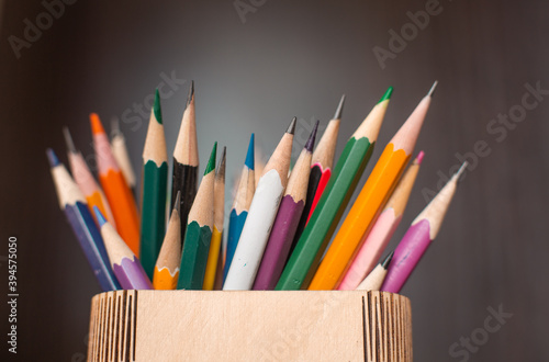 a lot of sharp colored pencils for drawing on a dark background
 photo