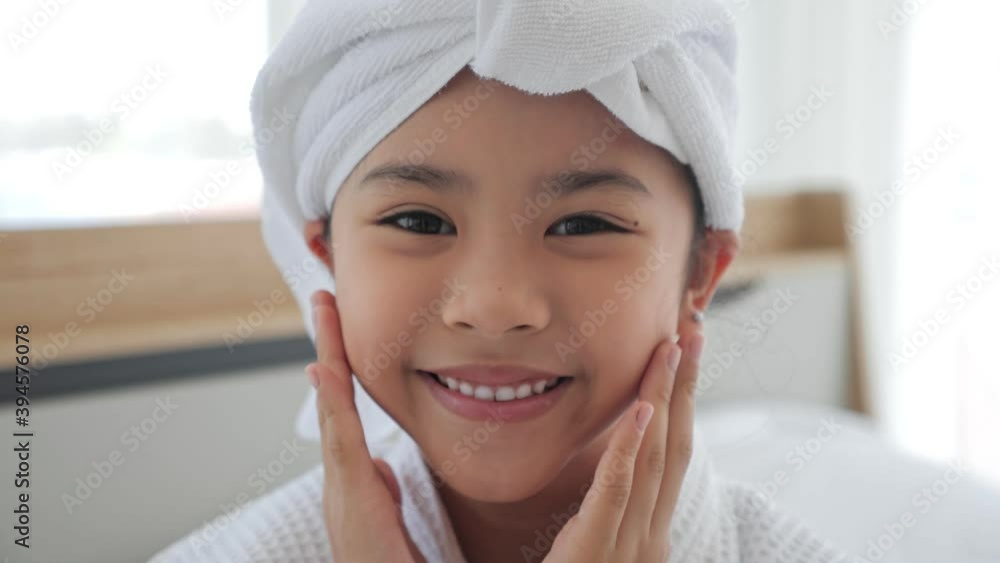 Asian cute little girl rest beauty care wearing towels look at camera at home, skincare kid beauty and glamour. Smiling asian girl wearing bathrobe and towel after shower. Asian cute little girl rest beauty care wearing towels look at camera at home, skincare kid beauty and glamour. Smiling asian girl wearing bathrobe and towel after shower.