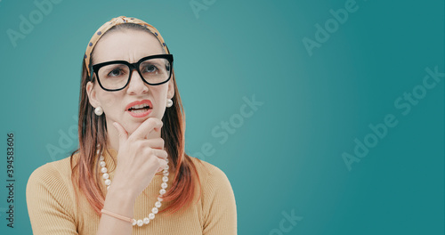 Confused clueless woman thinking with hand on chin