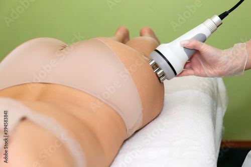 Anti-cellulite massage RF-lifting of thighs.