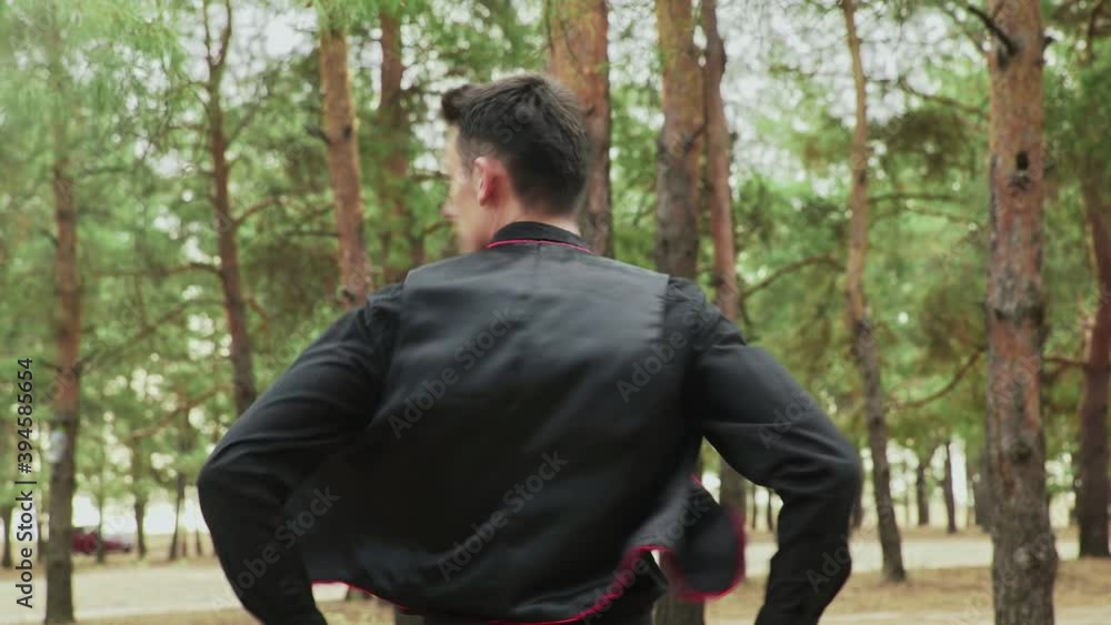 Close up of young man in black costume are dancing Traditional Spanish dance in summer forest Close up of young man in black costume are dancing Traditional Spanish dance in summer forest