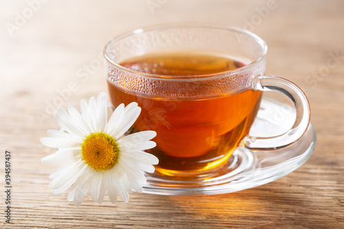 cup of herbal chamomile tea with fresh chamomile flower