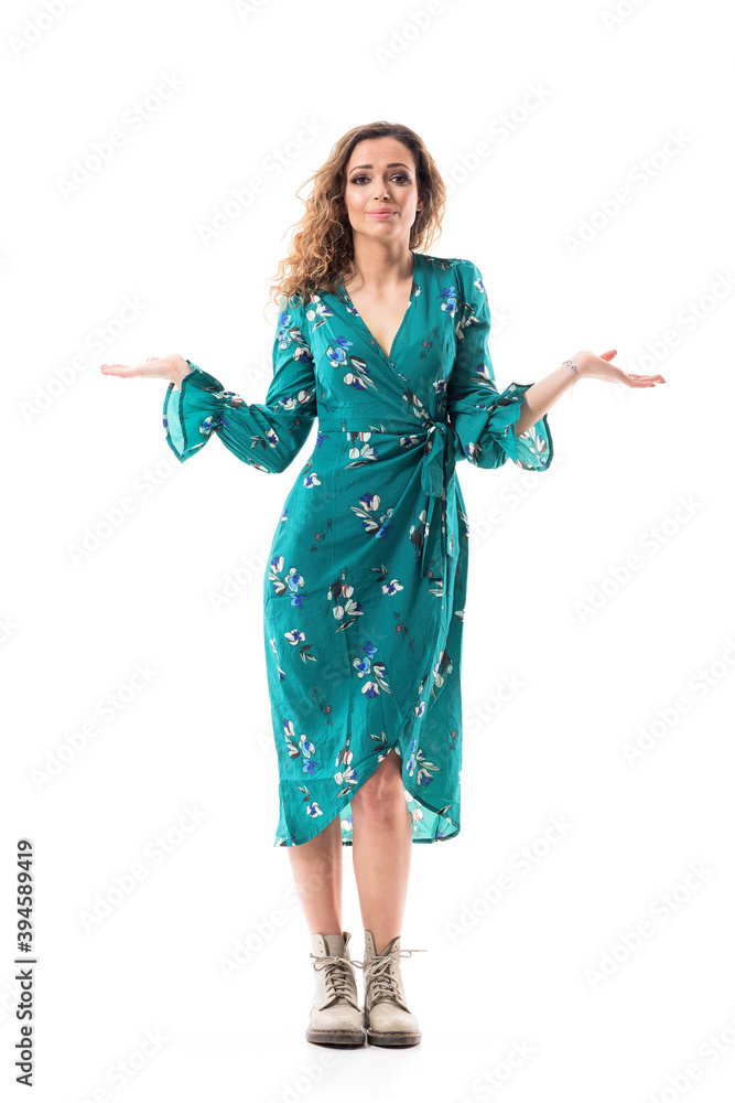 Puzzled young stylish woman apologize with innocent expression and raised hands. Full body isolated on white background.