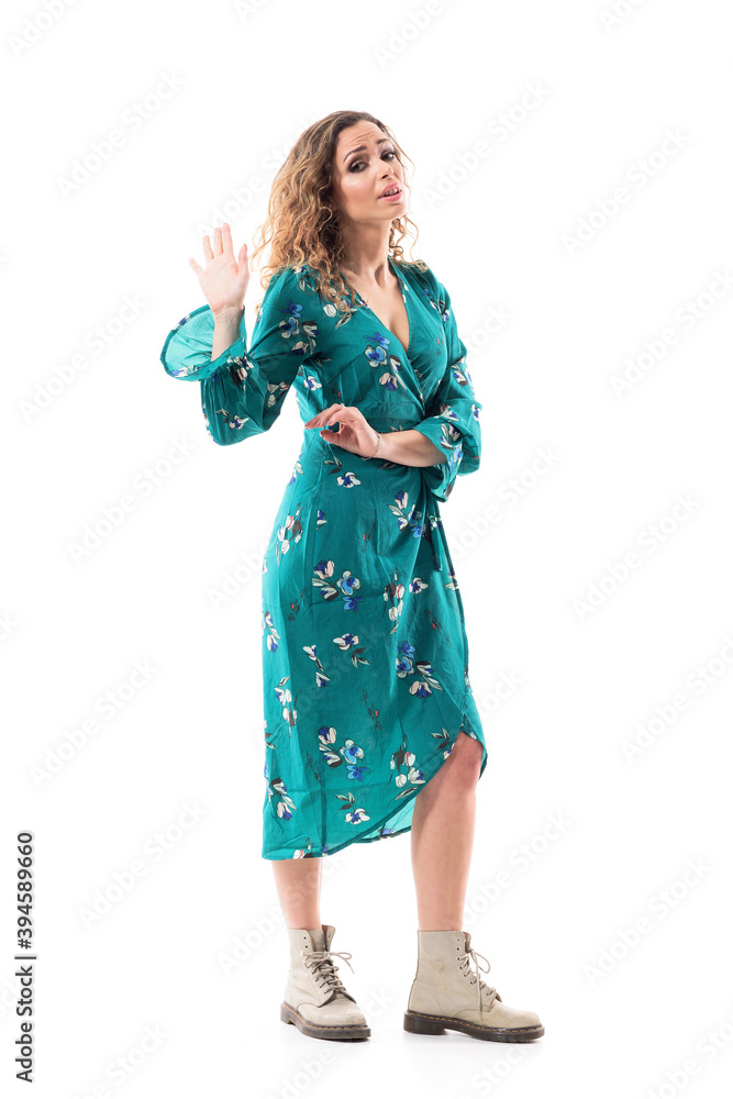 Angry arguing young woman looking at camera with talk to the hand gesture. Full body isolated on white background. Angry arguing young woman looking at camera with talk to the hand gesture. Full body isolated on white background.