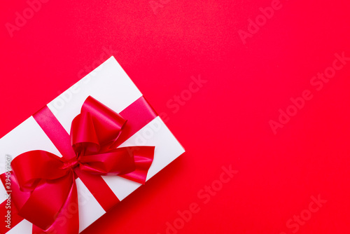 Top view White gift box ribbon flat lay red background.Christmas concept.