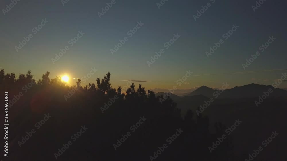 On top of a mountain with the summit cross at sunset On top of a mountain with the summit cross at sunset