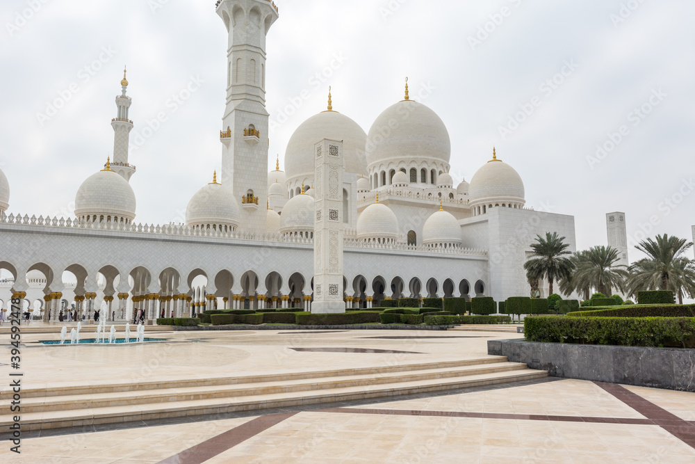 White Grand Mosque built with marble stone against blue sky, also called Sheikh Zayed Grand Mosque in Abu Dhabi, UAE