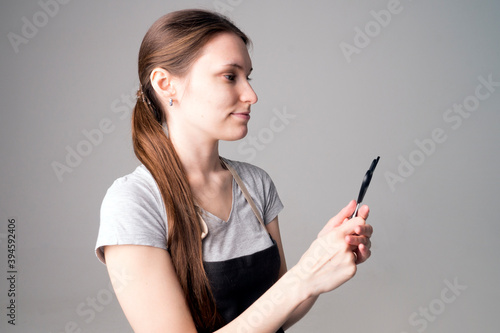 Closeup of a young female hairdresser