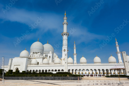 White Grand Mosque built with marble stone against blue sky, also called Sheikh Zayed Grand Mosque in Abu Dhabi, UAE