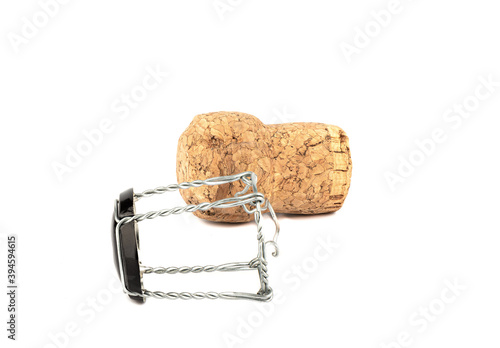 Champagne cork and muselet separately on a white background.