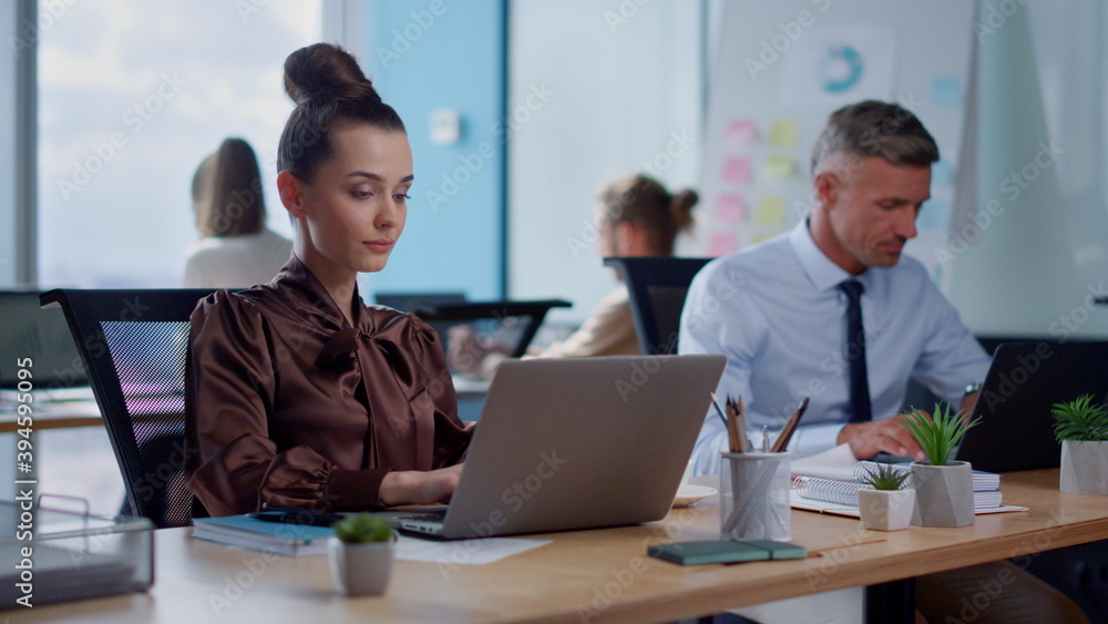 Pensive businesswoman using laptop.Female professional drinking coffee in office Pensive businesswoman using laptop.Female professional drinking coffee in office