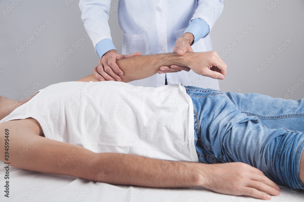 Caucasian doctor massaging patient hand. Caucasian doctor massaging patient hand.