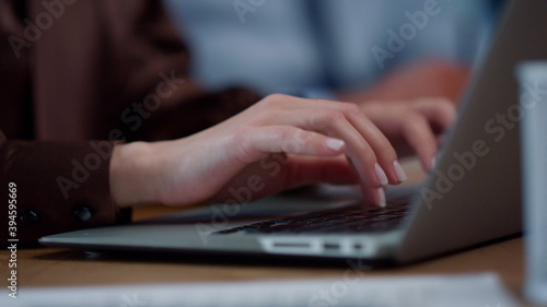 Businesswoman hands typing on laptop computer. Unknown woman working on computer