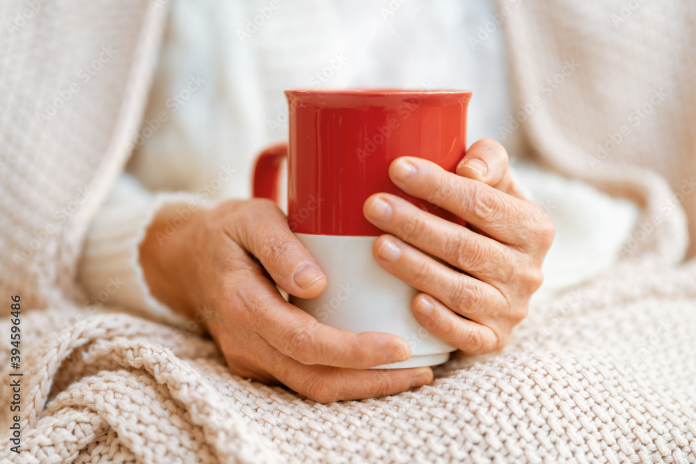 Senior woman with a mug in hands close up Senior woman with a mug in hands close up