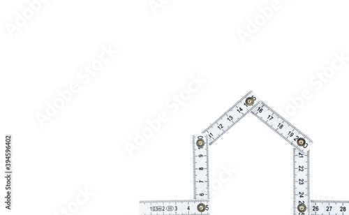 Folding rule in the shape of a house, white background and copy space