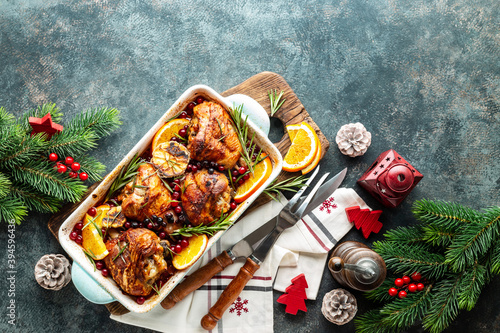 Christmas turkey legs baked with cranberries, orange and rosemary. Delicious festive dish for Christmas time. Top view,  christmas food background with space for a text