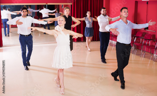 Young people practicing passionate samba in dance class