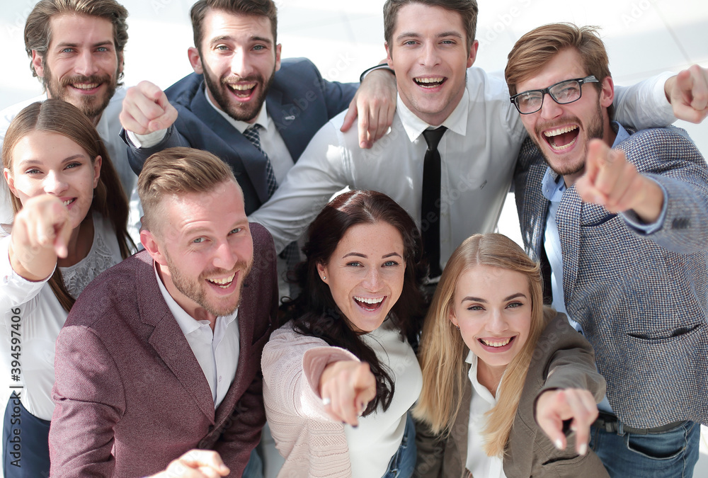 happy team of successful young business people pointing at you happy team of successful young business people pointing at you