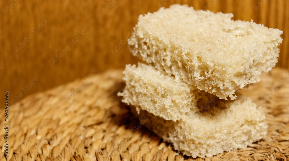Slices of fresh gray bread on a wooden background. Slices of fresh gray bread on a wooden background.