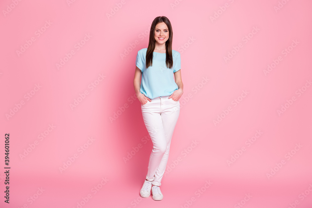 Full body photo of charming lady toothy beaming smile wear casual t-shirt pants sneakers isolated pink color background Full body photo of charming lady toothy beaming smile wear casual t-shirt pants sneakers isolated pink color background