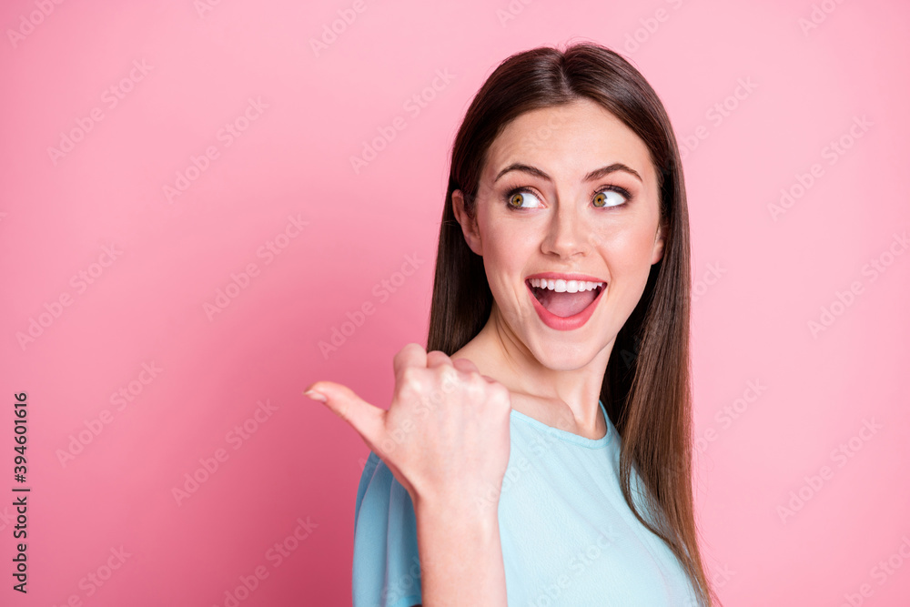 Photo of surprised girl point thumb finger wear blue outfit isolated over pink color background Photo of surprised girl point thumb finger wear blue outfit isolated over pink color background