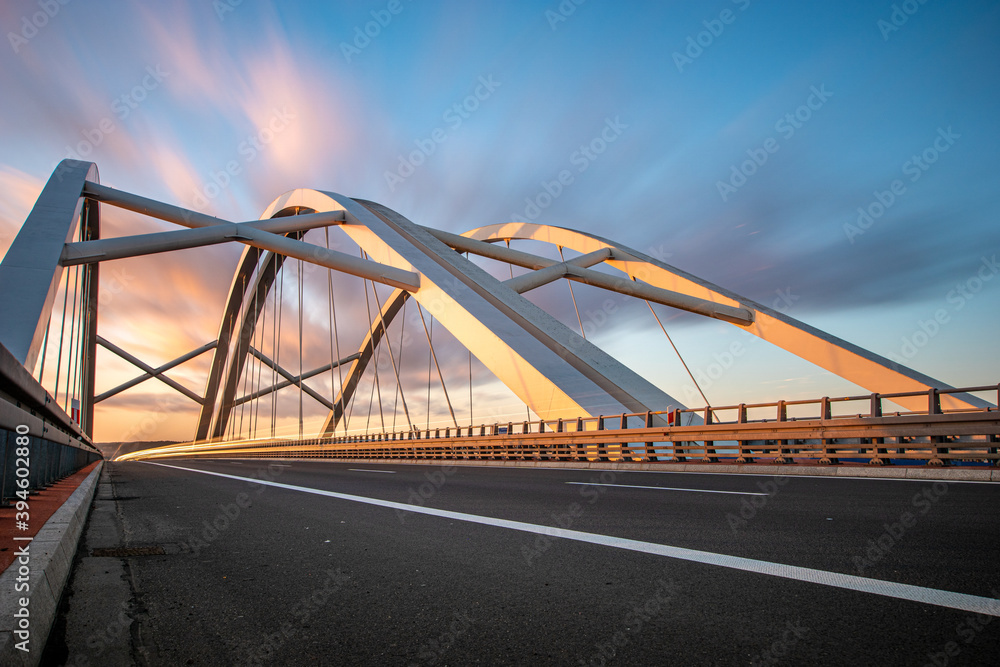 Modern construction highway bridge at sunset Modern construction highway bridge at sunset