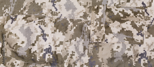 Fragment of pants of digital camouflage fabric with different pockets