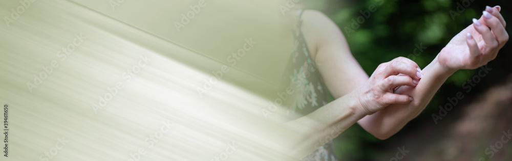 Woman scratching her arm; panoramic banner Woman scratching her arm; panoramic banner