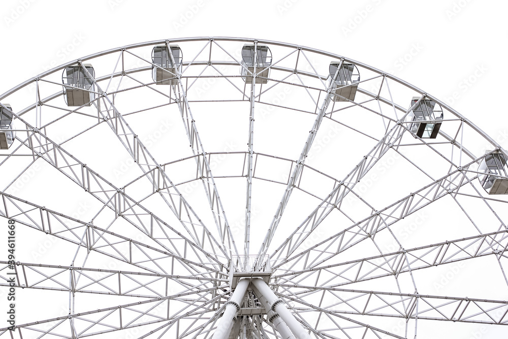 Modern white Ferris wheel in the central park against sky. Entertainment, attraction, amusement park, minimal concept or background. Modern white Ferris wheel in the central park against sky. Entertainment, attraction, amusement park, minimal concept or background.