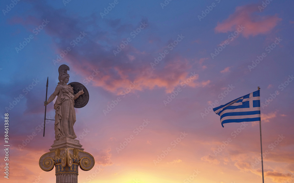 Athena the ancient goddess of knowledge and wisdom and Greek flag under dramatic sky, Athens Greece Athena the ancient goddess of knowledge and wisdom and Greek flag under dramatic sky, Athens Greece