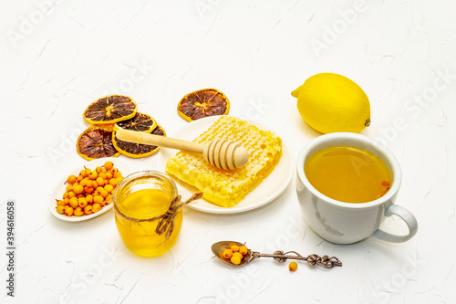 Healing sea-buckthorn tea with honeycombs and lemon