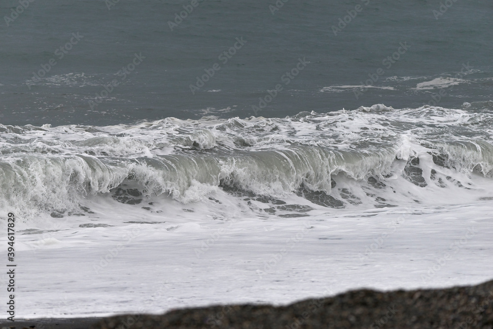 detail of a wave in a day of rough sea with strong rain and wind