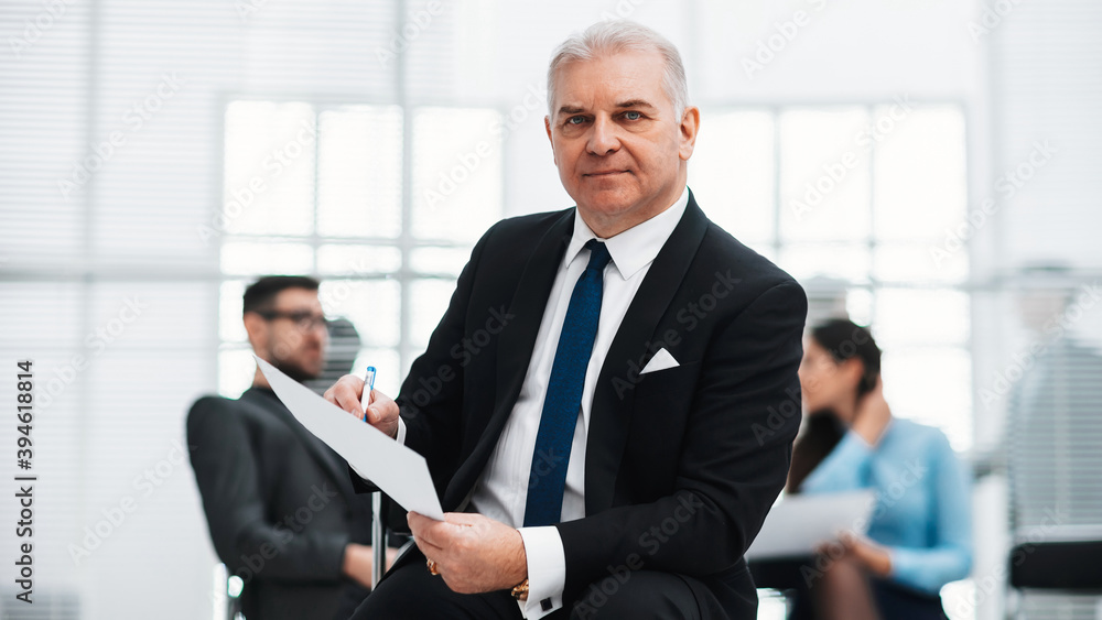 close up. investment consultant checking a business document close up. investment consultant checking a business document